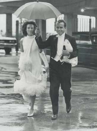 Yesterday's rain didn't help matters but Mr. and Mrs. Phillip Boylen came prepared with an umbrella. The ball was great success with new and old friends getting a chance to meet. The club was elaborately decorated for the occasion with 4,000 roses adding a touch of color.