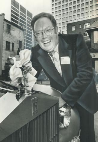 Win a Rolls, Barry Brown, president of the Juvenile Diabetes Research Foundation, polishes the hood ornament of a Rolls-Royce to be raffled Nov.