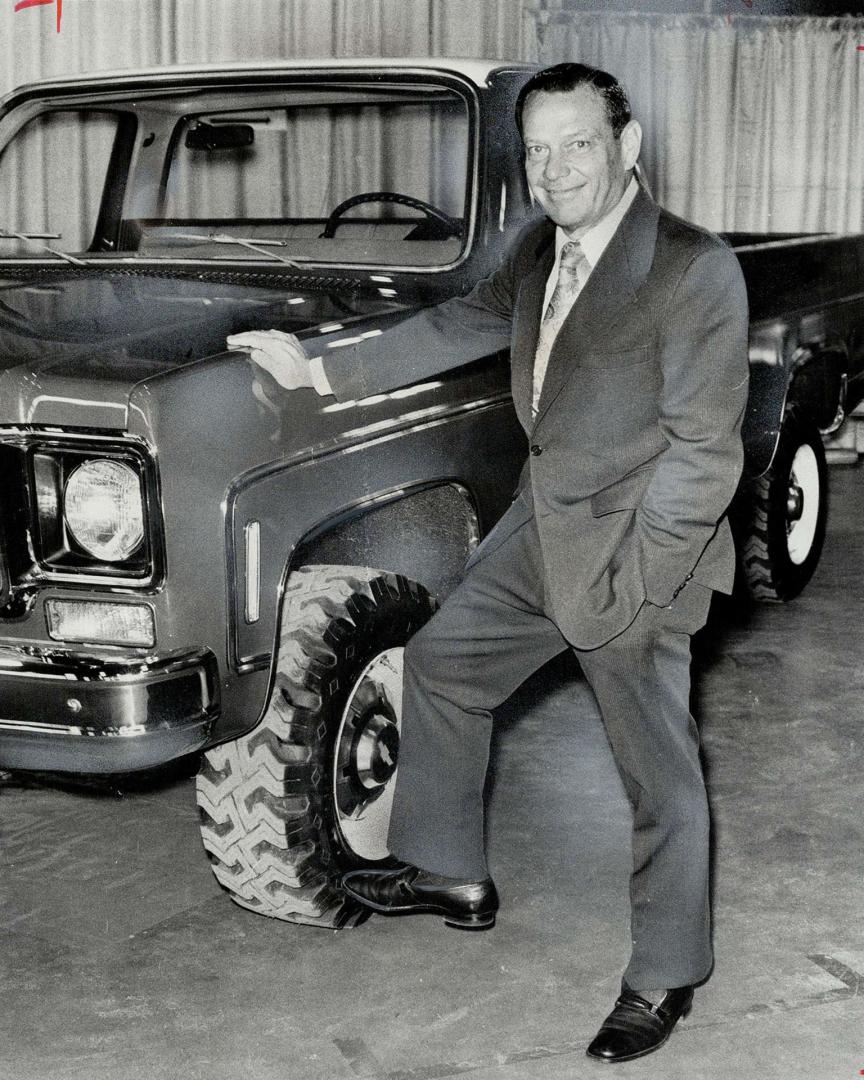 Time-Honored test of kicking the tires is administered by GM Canada's John D. Baker. The pickup truck-a 4-whell-drive Cheyenne Super 20-stood up well to presidential punt. 1974-model GM vehicles were on display at Moss Park.