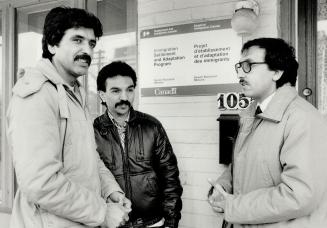 Making a new home: Afghan House director Saber Bereia, right, greets Mohamad Popal, left, and Waheen Mansuri, two of the Afghan refugees now living in Metro.