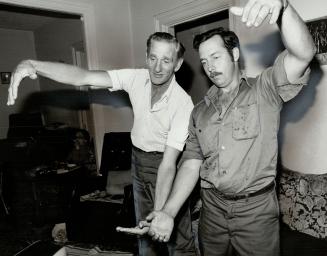 Fish story: Gaston (left) and John Claude Bergeron show how big around the creature they saw was.