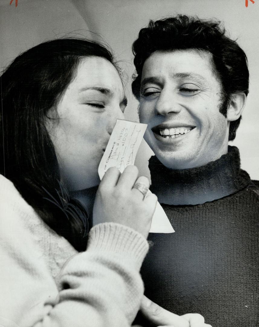 Look of relief: Mr. and Mrs. Guido Bianco, the immigrants who lost their $2,800 life-savings on the street after being in the country only three weeks, show their happiness after receiving cheque to help Guido buy tools and get a job.