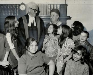 Visiting old city hall with pupils from Grade 5 of Dewson Public School, volunteer school helper 86-year-old Ida Seigal chats with Judge Tupper Bigelow in his chambers after the group sat in on his court for more than two hours. Judge Bigelow and Mrs. Seigal served on school board together during 1930s.