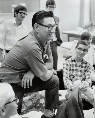 Seed Director Les Birmingham (left) talks to some of the participated in the program he ran for the Toronto Board of mer. He said the two-month project cost less than $2,000 and the young people who Education this summer will likely be repeated next year. He and other leaders received no pay. [Incomplete]