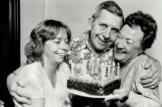 Best is yet to come: Bill Bland, with 62nd birthday cake, gets a hug from wife Isabelle (right), while Operatins Springboard director Joice Lawson joins the fun.