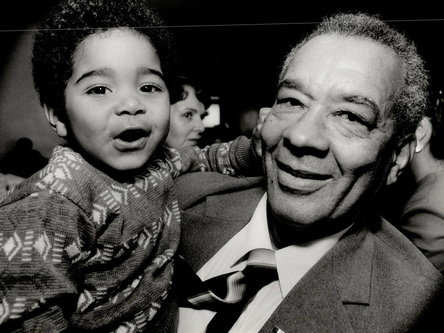 Proud grandson: Geoffrey Stines, 3, was among the 100 people at York Community Hall yesterday who honored John Brooks, 62, for his work with Jamaican and community groups.