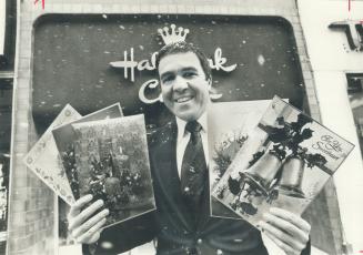 One of Santa's helpers, Rich Cairns, president of Coutts Hallmark Cards Ltd. shows off some of the more expensive cards that are selling well this year - sor far. He is standing in front of Coutts Hallmark store on Yonge St., opposite Eaton Centre. The $250 million a year industry is watching postal workers, fearfull of anther walkout similar to 1975, which also spolied 1976.