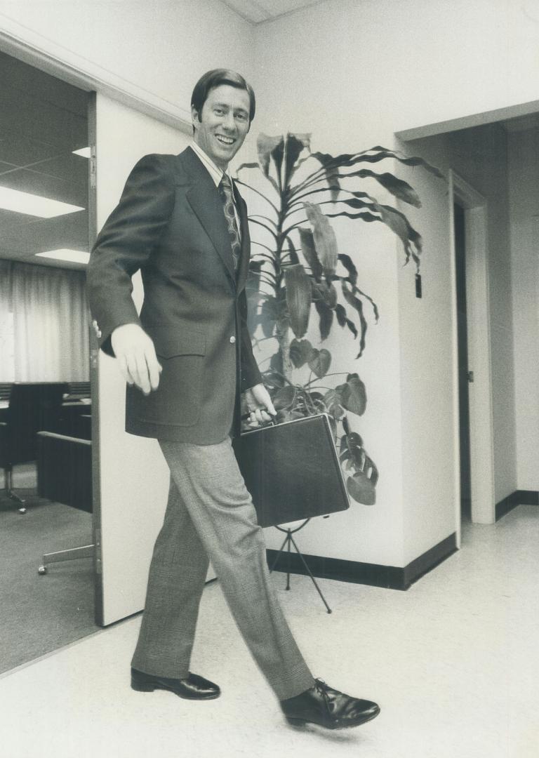 Eric Cmapbell-Smith, executive vice-president of the Toronto Home Builders Association, wears 2-button, single-breasted navy hopsacking blazer. Detailing included patch flap pockets, tack pleats and half belt in back.