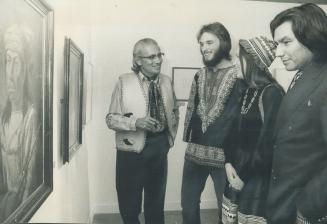 Ojibwa Indian Walter Currie (left), who opened the Royal Ontario Museum's 60th anniversary exhibit of British artist Paul Kane's paintings yesterday talks with his daughter, Leslie, student Philip Fischer (second from left) and Johnny Yesno, and Ojibwa and producer of CBC's Our Native Land in exhibition hall.