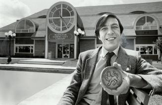 Award-winning architect: Philip Carter proudly displays the Governor-General medal he won for his design of the Markham Community Library. The $900,000 library blends in with the 19th-century style and atmosphere of the old village of Markham's Main St. Carter, 42, received his award at a ceremony held in Winnipeg.