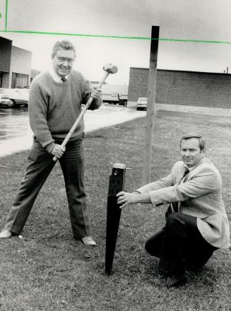 Heads up: Ernie Clegg, with the hammer, and Doug Mepham, holding the spike, have invested their life savings in introducing the Metpost to Canada. They expect to sell $3.5 million worth of the post supports in hardware and building supply stores across Canada this year.