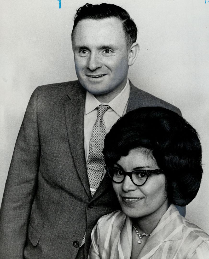 Mr. and Mrs. Richard Coatsworth posed for photographer in their Douglas Ave. home. Mrs. Coatsworth translates government news releases into Cree.