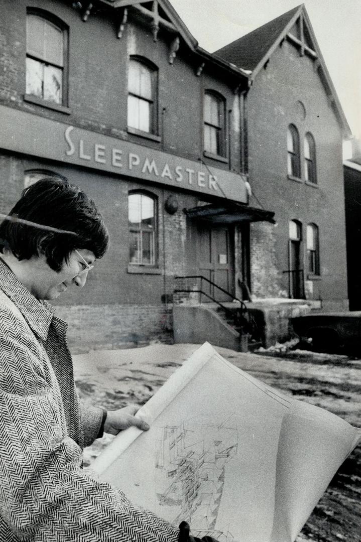 Mattress factory at 41 Spruce St. in Cabbagetown will become $65,000 townhouses. Patrick Comerford studies the plans for the 16 units which have been exempted from the 24-foot height bylaw in the area. Comerford and architect Ferdinand Wagner planned the $900,000 project.