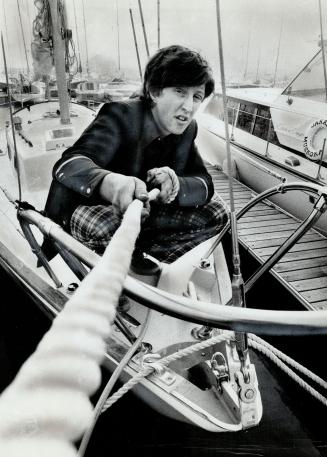 Hard at work, student K. Douglas Crocker, 21, moors a yacht at Ontario Place marina. Crocker decided to set up his own vacation service to relieve boatowners of cleaning, bartending and other chores so they could enjoy themselves.