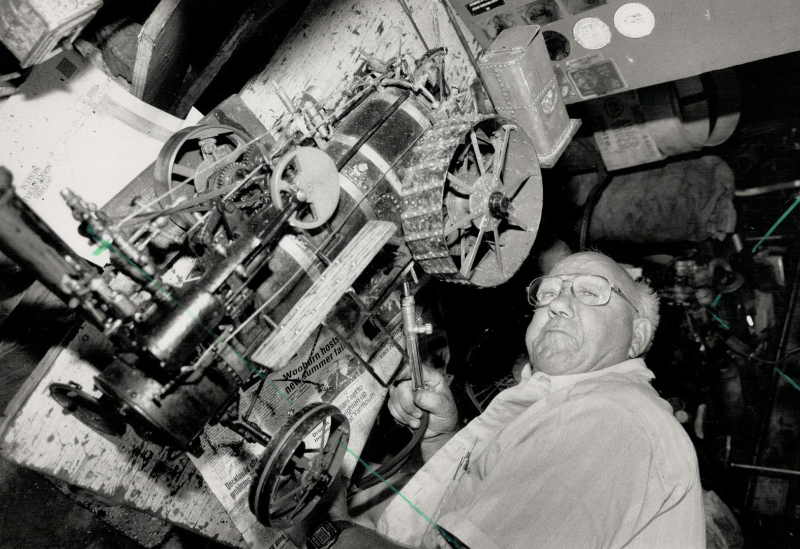 Final check: John Crook of Oshawa inspects one of the steam engines he has built. Some of his collection will be on display at the Steam Threshing Days in Uxbridge this weekend. He grew to love steam engines while helping on his father's farm in the 1930s.