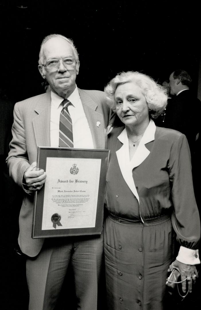 Posthumous honor: Robert and Irene Crowe hold the OPP bravery award given last night fo their late son, Mark. He was one of 21 people honored for heroism.