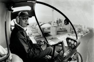 Hollcopter flight instructor Peter Crry pilots a Robinson R22 overr the Toronto waterfront. Curry, who has logged a lengthey 10,000 flying homourse in his career, has been beachig at toronto Island Airport of about years. Total cost to earna private helicopter licence is about $15,000 triple the cost in other aircraft.