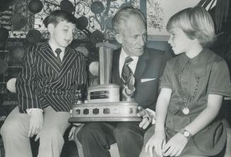 Holding his award as Natinal Truck Hero of the Year, before it official presentation today, driver Ted Daubreville, 53, of Toronto, shows it to Carol MeCheshey, 10, of Grimsby, one of children in school bus he swerved to avoid.