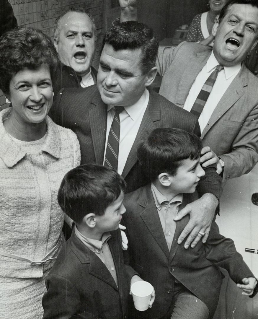 Official Liberal Candidate and winner in High Park, Walter Deakon, with wife and sons Tim, 10, and Tony, 8, was congratulated by all but one opponent: Ralph Cowan, cut off by the Liberal Party, ran badly but wouldn't concede he was defeated. This was a contest, Cowan replied bleakly.