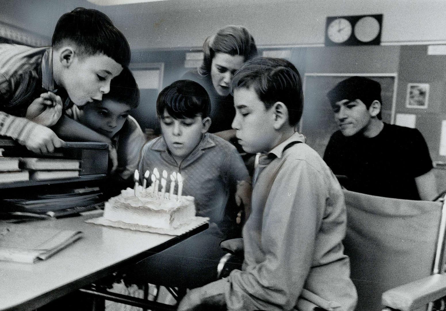 Waiting happily for artificial legs to be fitted, Kenneth Davidson, right, celebrated his 12th birthday yesterday at Ontario Crippled Children's Centre. With him are classmates, from left, Dennis, Neil, Frank and teacher Janet Fraser.