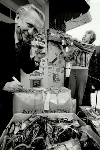 Vision of charity: Ken Davis of Toronto and wife Ruth check used eyeglasses they are taking to Haiti for distribution to the needy.