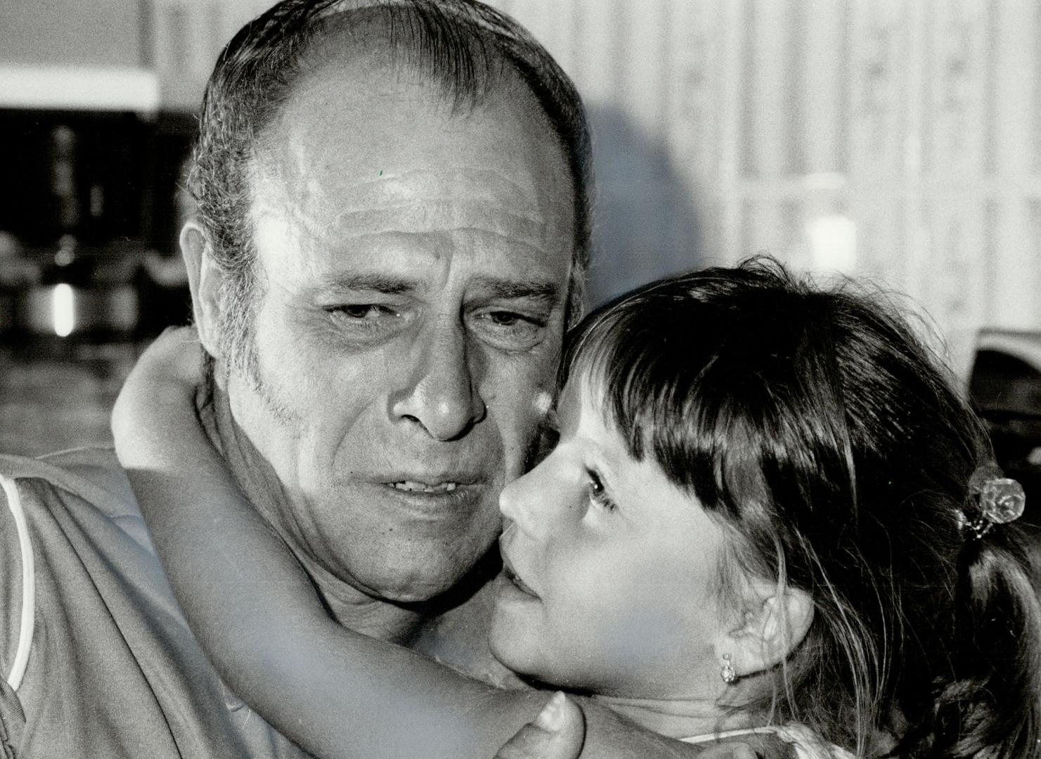 Terrifying ordeal: Manuel De Mendonca, at home after being held captive for 99 hours while his abductors drove his van across the country, weeps in the arms of his daughter Nancy, 5, as her recounts the terror of his ordeal.