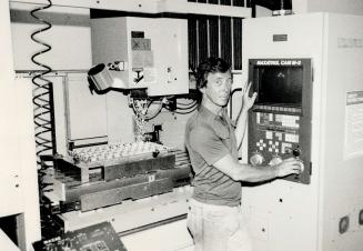 Factory skilled: Peter Delve, who owns Future Industries in Scarborough, programs a high-tech machine that will keep his plant operating all night while he goes home to relax.