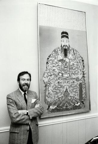 Boldly dramatic: Top Toronto designer Robert Dirstein, right, with his huge embroidered portrait of a mandarin, found about 10 years ago at a Toronto estate auction.