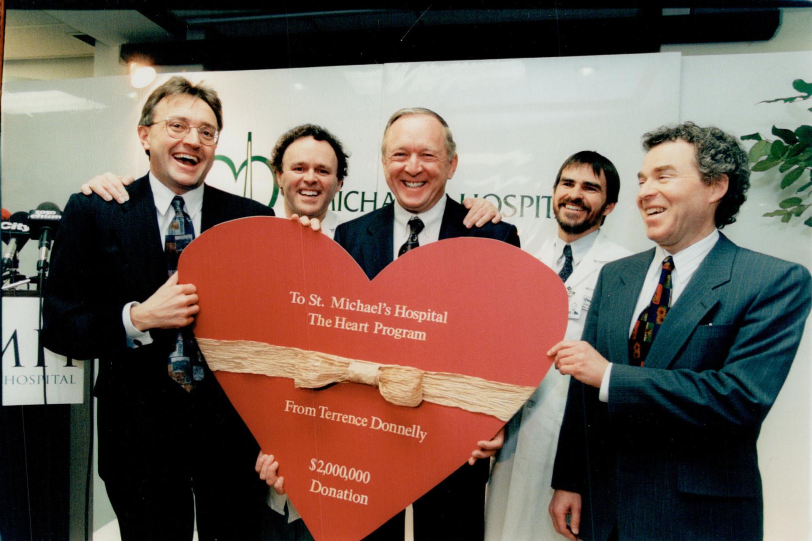 All Smiles: Terrence Donnelly, centre, got warm reception at St. Michael's Hospital yesterday. He's flanked, from left, by Jeff Lozon, Dr. Lee Errett, Dr. Duncan Stewart and Dr. Eliot Phillipson.