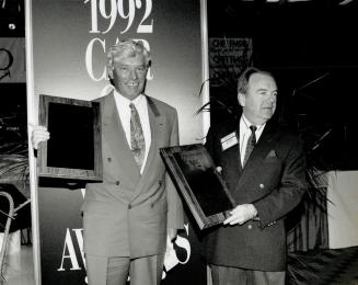 In The Lead: BMW Canada chief Victor Doolan, left, accepts the Automobile Journalists Association of Canada's Car of the Year award from Alan McPhee, AJAC president.