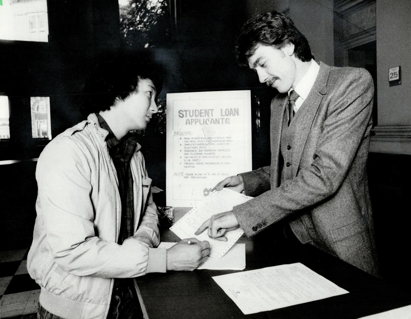 Paper flood: Director of Ontario's student awards program, Bill Clarkson, above, sifts through a mountain of applications from students seeking financial assistance with their post-secondary education.