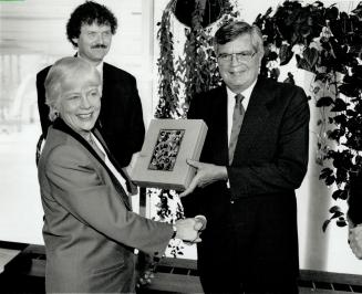 Courtesy call: Canada 125 organizer Claude Dupras gives Toronto Mayor June Rowlands a gift yesterday, as Councillor Chris Korwin-Kuczynski looks on.