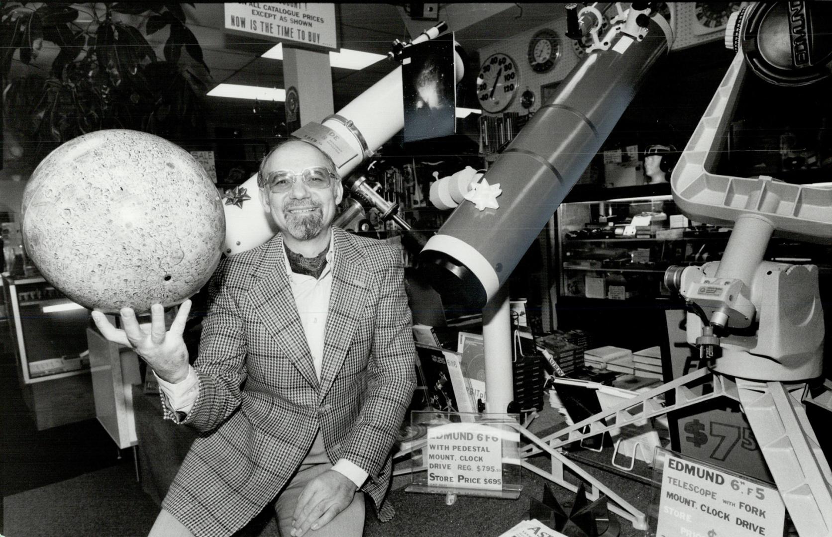 Adventure centre: Evan Efston balances a miniature moon on the tips of his fingers at Efstonscience, a store he opened in North York about nine years ago.