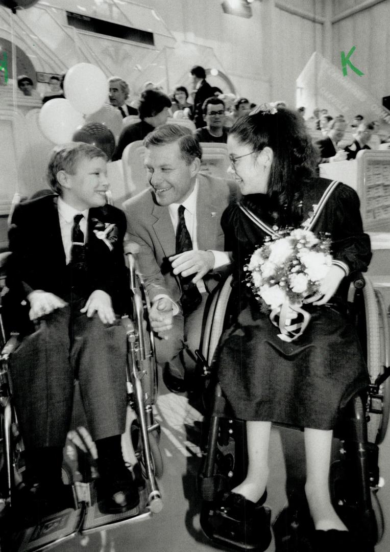 Good times: Peter Ely, executive director of the Easter Seals Society, chats with Jeremy Davis, 12, and Colleen McKane, 11, yesterday at the ninth annual telethon.