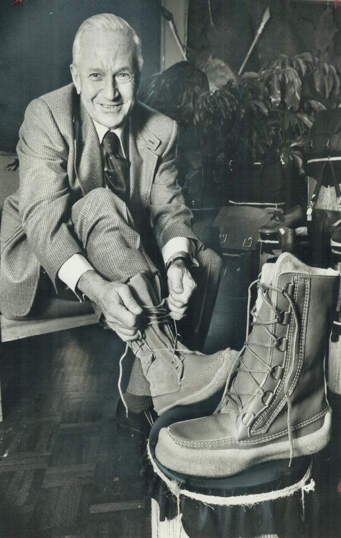 Fred Glasser, 63, president of the Tanners Association of Canada, tries on a pair of Quebec made mukluks at the fall show of the Canadian leather industry at the Skyline hotel. Leather is comfortable because it breathes and has memory, he says. Leather re