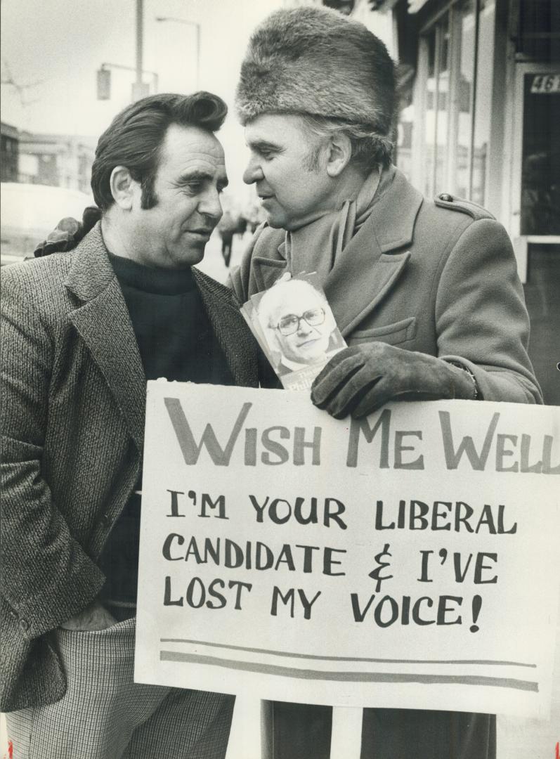 Soft words. Liberal candidate Philip Gigantes (right) has lost his voice but not his chutzpah - he's out mainstreeting along the Danforth in Broadview-Greewood riding, and carrying a sign to let people like John Bovetas know he can only talk softly.