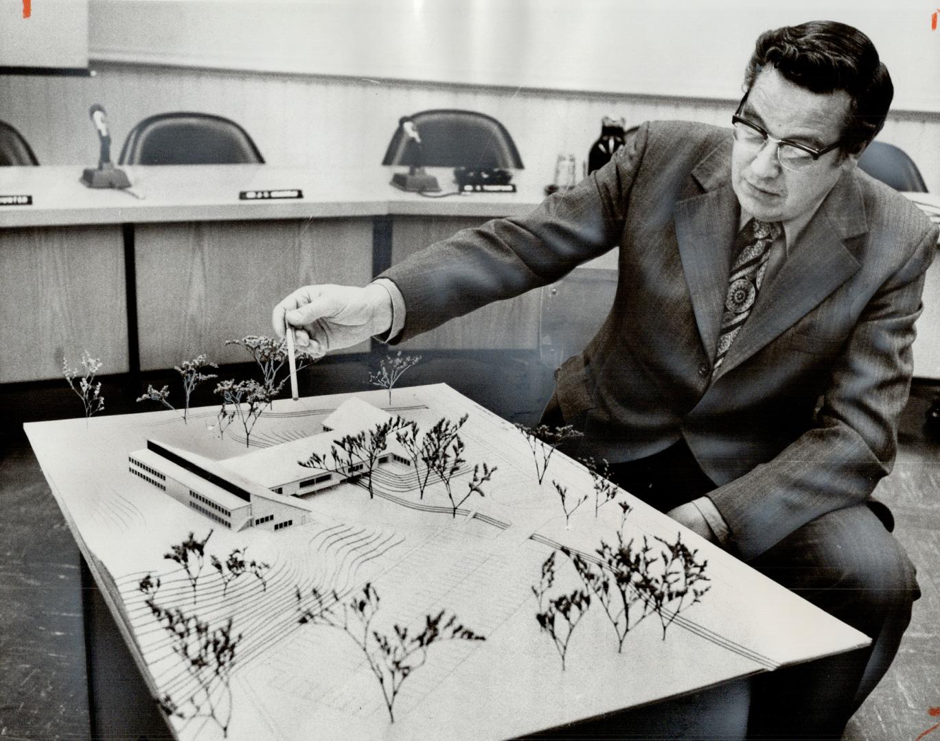 A $1.7 million building to house the York Region Board of Education and the Aurora municipal offices is going to be built, George Ford, superintendent of business for the board, examines a model of it. It will be built on Wellington St. just west of Yonge