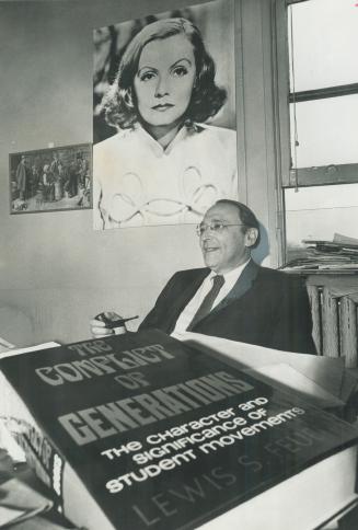 Greta Garbo, star of another era, looks down on Univeristy of Toronto Professor Lewis Feuer and his new book while he explains his theory that the generation gap is behind today's student unrest.