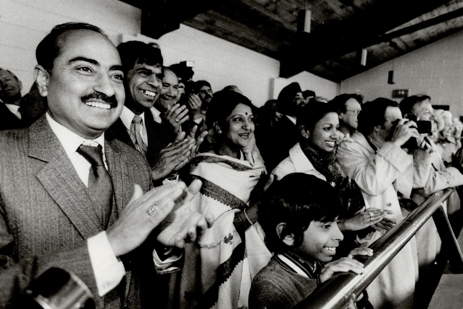 Rinoceros party: Indian High Commissioner Kalarickal Fabian, second from left, and wife Usha applaud yesterday at the Metro Zoo as Vinu, the stubborn Indian rhinoceros, emerges from behind cover after 20 minutes of prodding. A crowd of 50, including comed