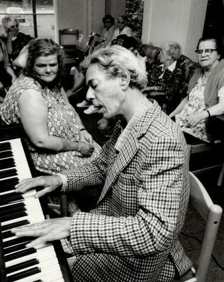 Feeling good: Clive Fell, at the piano, and Linda Shanley, left, who were reduced to living in Metro Toronto parks after Shanley was evicted from government housing, are settling in nicely at the Mount Forest, Ont., lodge at which they were offered an apa