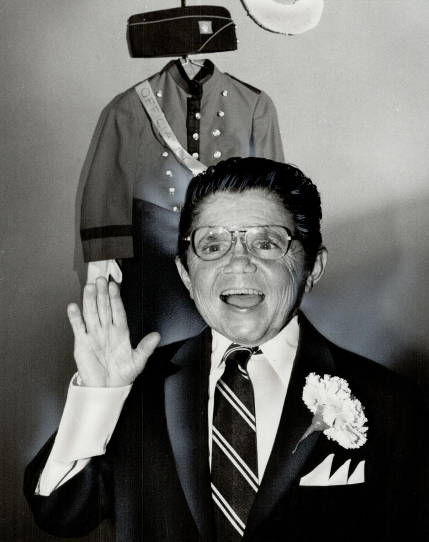 Waving goodby: Fergie Ferguson, 53, hung up his hat and uniform for the final time last night after 35 years as a page boy at the Royal York Hotel. Ferguson said he was last hotel page left in Toronto.