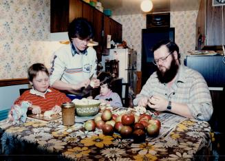 Judy and Bill Fillier and their children economize by buying fruit at country markets and discount stores and making their own preserves. The Filliers call themselves 'working poor'.