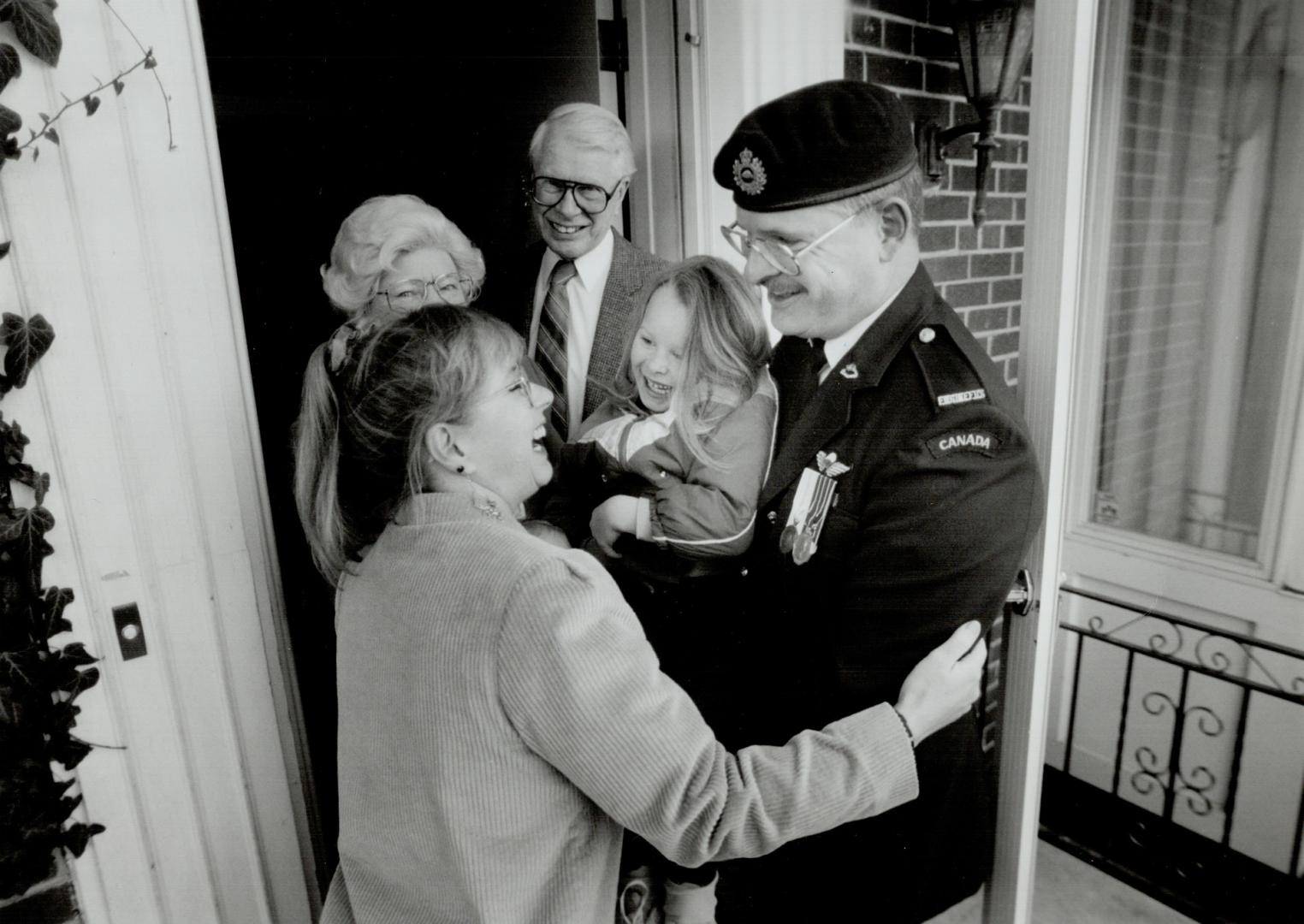 At ease: Major Paul Fredenberg enjoys Christmas holiday with daughter Amanda, wife Gall and parents Ann and Bill after eight months in Kuwait.