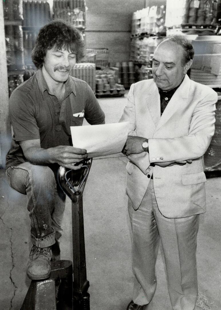 On the job: Former construction worker Vito Giovannetti, right, who now runs his own company, talks with Ed Boone, one of his new employees who was hired under a program set up by the Workers' Compensation Board to find jobs for disabled workers