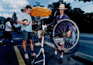 Outdoor bike repairs: Gary Burkhalter gets a quick gear adjustment (and lesson) from James Galbraith of Total Revolution Bicycle Repairs.