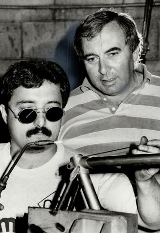 Big wheels: Bicycle manufacturer Joe Gardin, owner of Cambio Rino in Mississauga, watches as Giorgio Ferrali, from Toscanna, Italy, constructs a bicycle frame