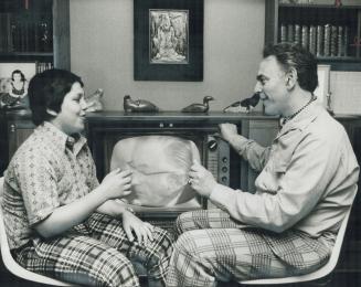 Thirteen-year-old Jonathan Goldberg and his father, David Goldberg, discuss television commercials in their home on Restwell Cres