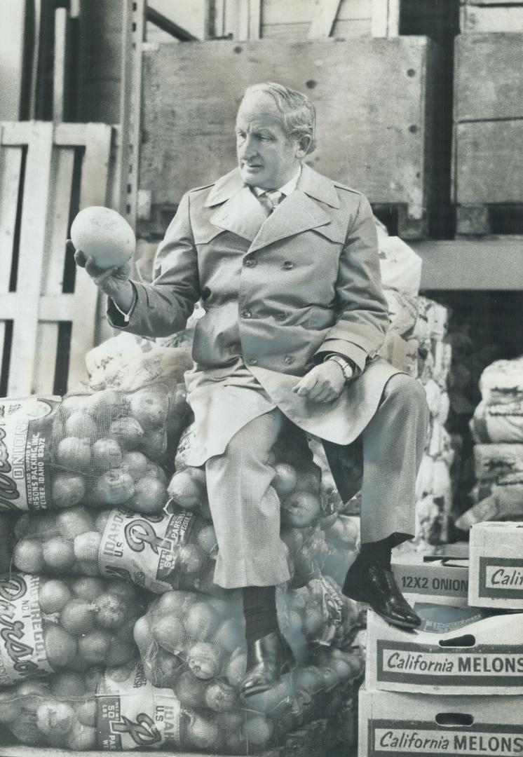 Still starting his day at 5 every morning, Julie Goodbaum checks a melon for quality before it goes on the shelves of one of his Sunnybrook Food Markets Stores