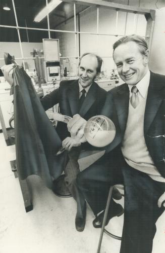 James Guillet holds container of concentrate crystals of discovery that allows plastic to disintegrate in sun over short period of time when mixed with raw material prior to manufacture