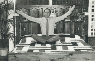 Wave of success: Charlie Hall, 39, inventor of the water bed, shows off a model at a manufactures' show at the Constellation Hotel.